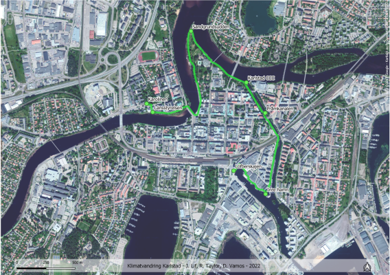 Flygfoto över Karlstad. På fotot är rutten för klimatriskvandringen markerad. Vandringen börjar vid Karolinen fortsätter till Länsstyrelsen Sandgrundsudden Karlstad CCC Pråmkanalen Inre hamn och avslutas vid Löfberskajen.