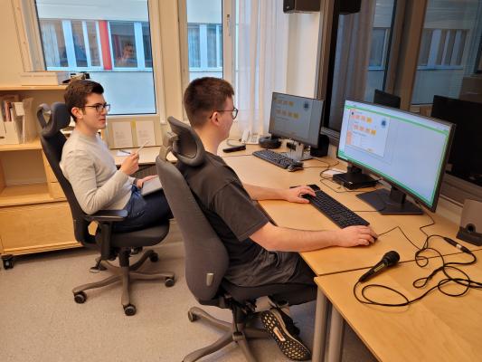 Two exchange students from Stuttgart, Germany, in the control room of the usability lab