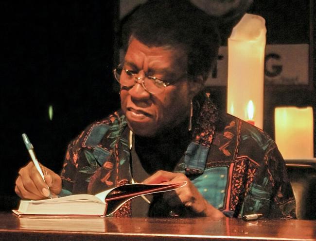 Butler signing a book