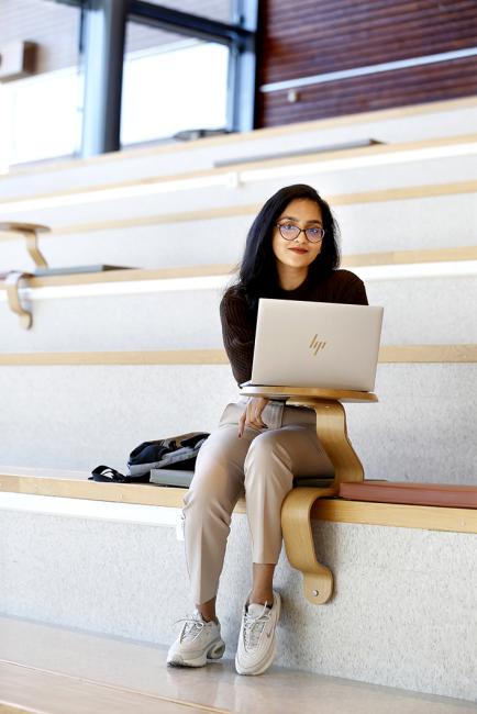 Female student sitting in a staircase